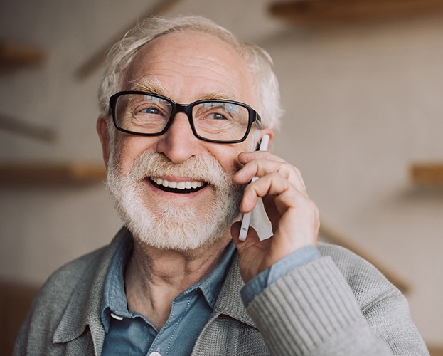 Older man smiling after senior dentistry