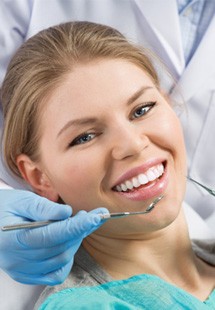 young woman smiling while visiting dentist 