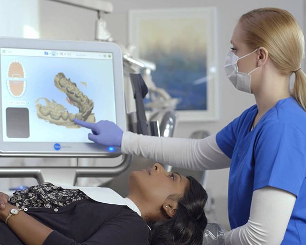 Dentist and patient looking at iTero intraoral images
