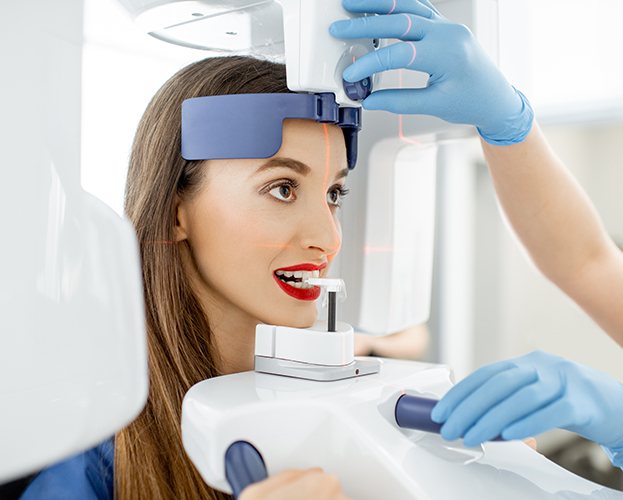 Woman receiving 3 D cone beam x-ray scans