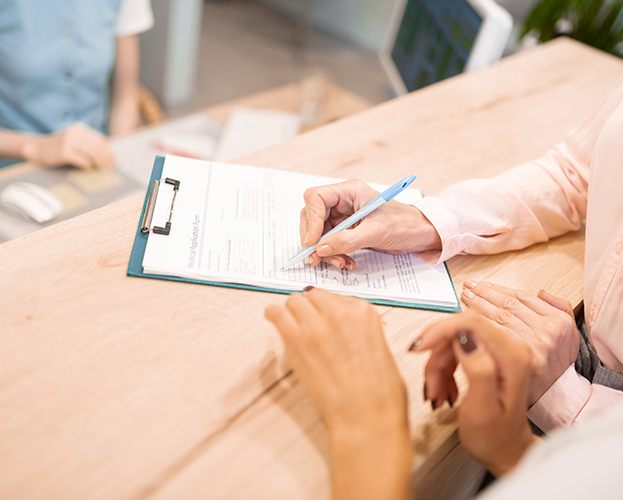 Patient filling out dental insurance forms