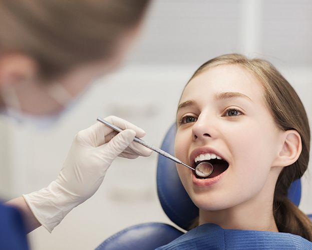 Young girl receiving children's dentistry visit