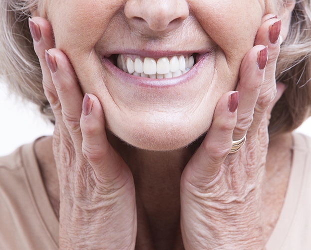 Older woman showing off flawless smile