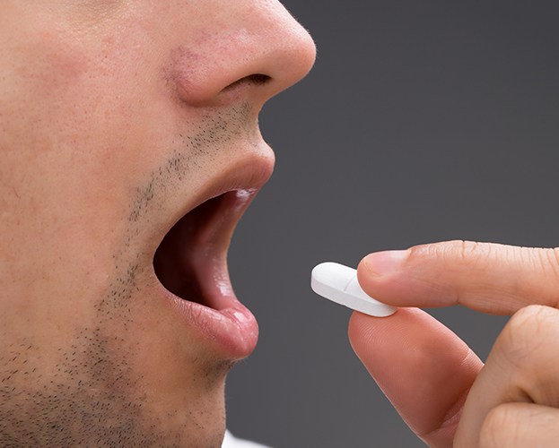 Patient taking oral conscious dental sedation pill