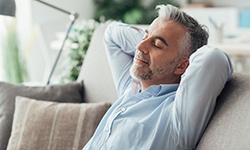  man taking it easy for post-op dental implants