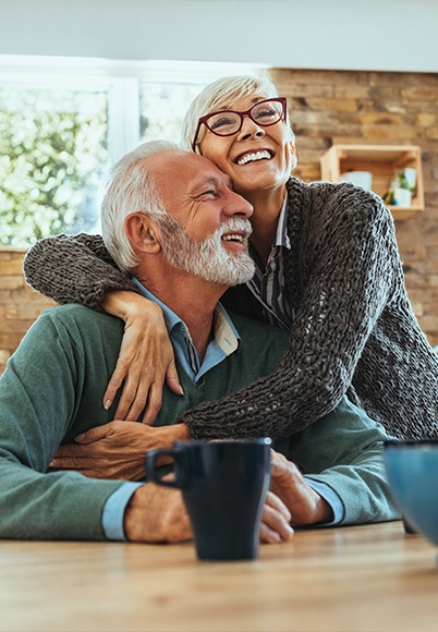 Smiling older man and woman drinking coffee