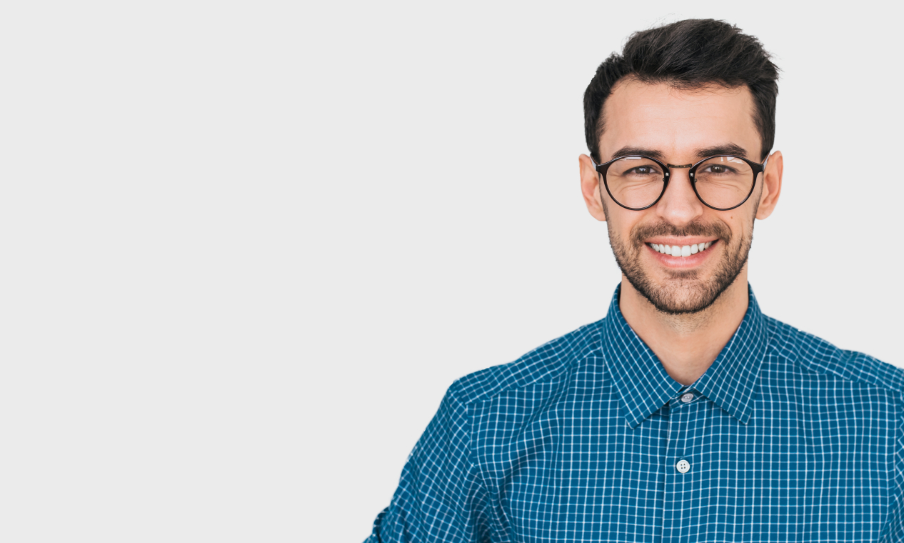 Smiling young man in blue plaid shirt