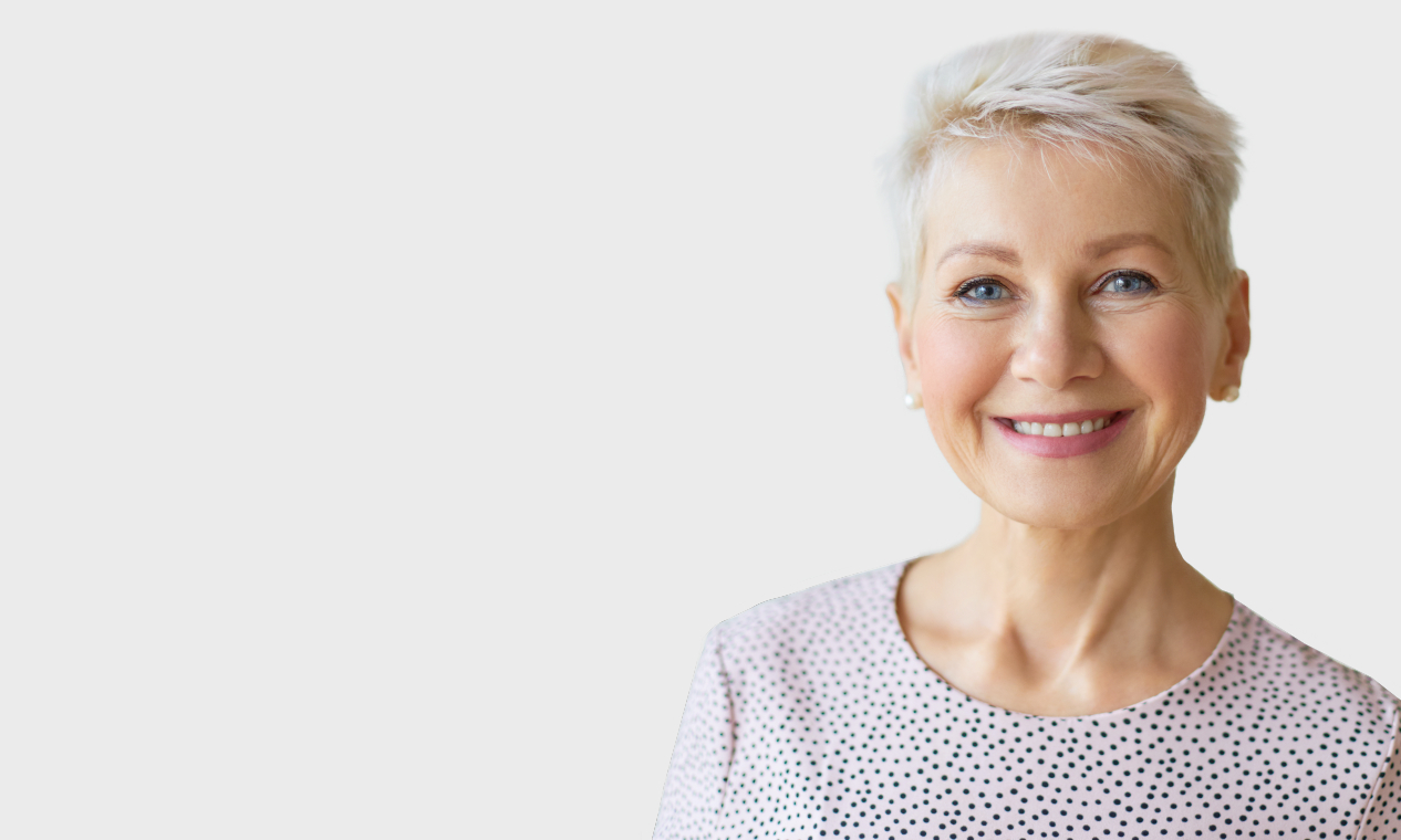 Smiling older woman in dotted blouse