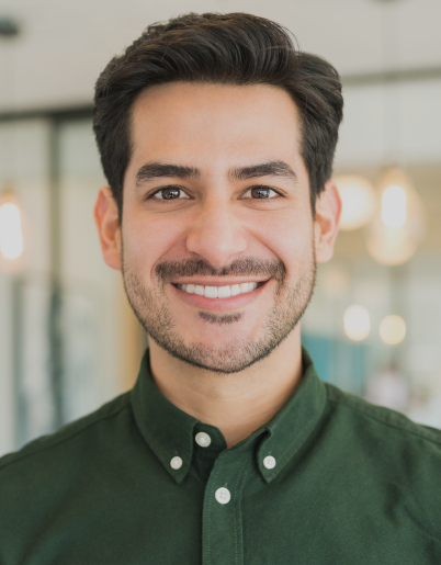 Smiling man in green button up shirt