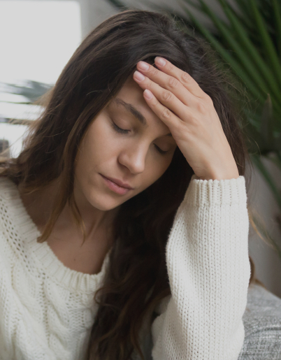 Young woman with eyes closed resting her head in her hand