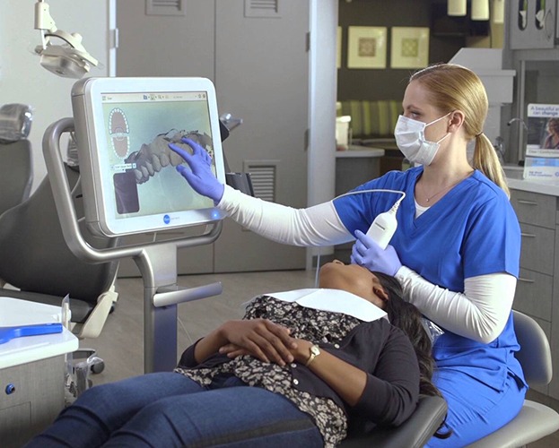 Dentist and patient looking at iTero intraoral images