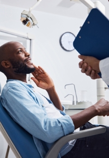 patient smiling while visiting dentist 