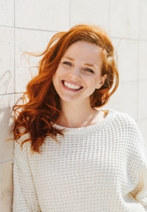 patient smiling while sitting in dental chair