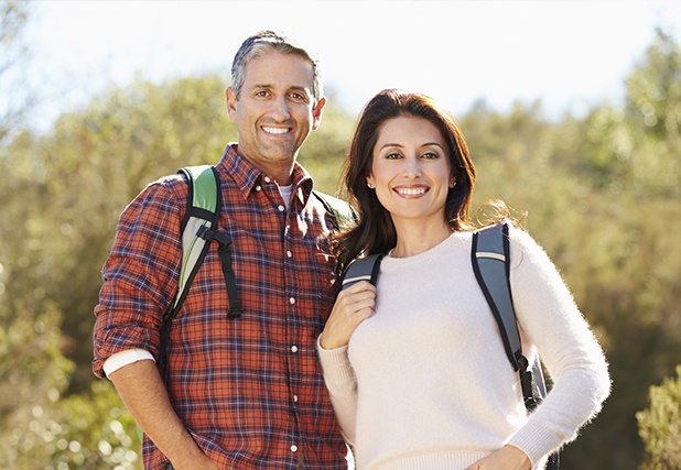 Man and woman smiling on a hike