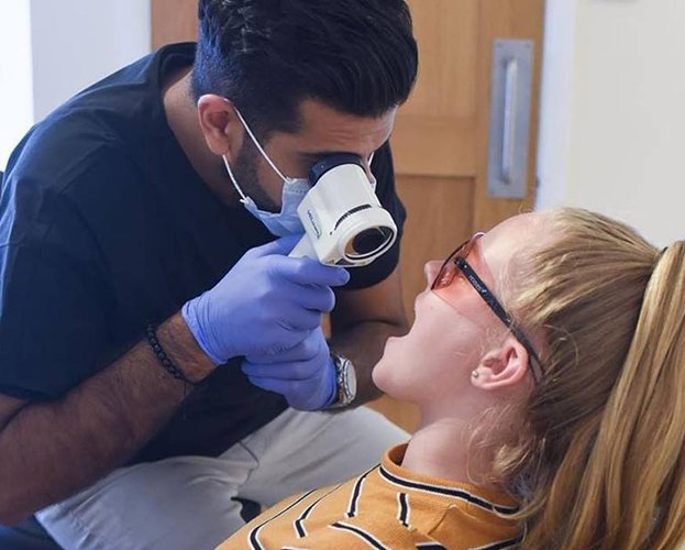 Patient receiving oral cancer screening