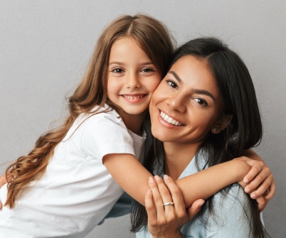 Mother and daughter smiling after children's dentistry visit