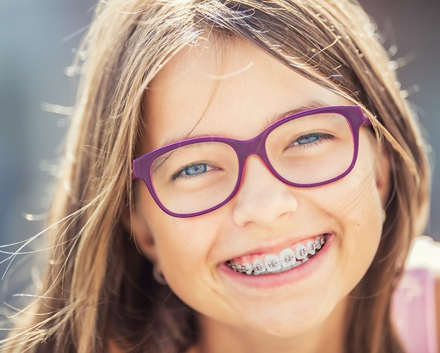 girl smiling with traditional braces in Williamsville