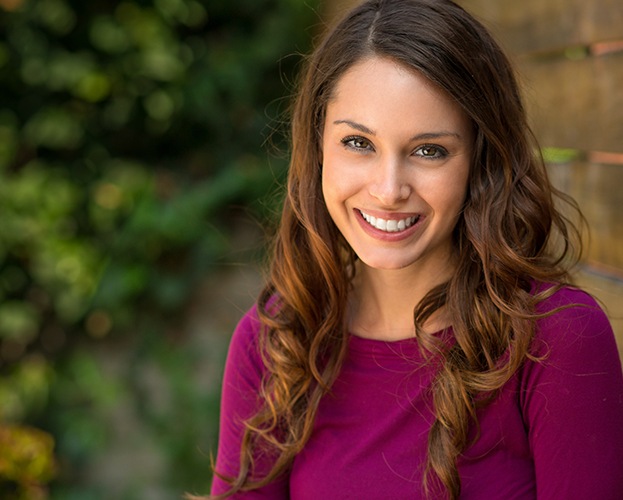 Woman with gorgeous smile after porcelain veneers