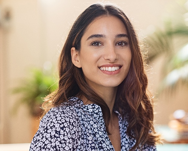 woman smiling after learning the cost of veneers in Williamsville