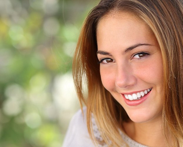 woman smiling after getting veneers in Williamsville