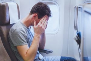 man in pain on plane