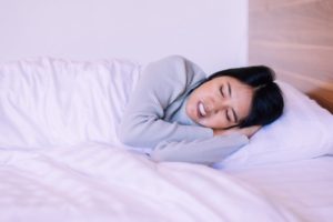 woman clenching her teeth while sleeping