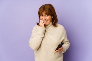 woman who is nervous about the transition to implant dentures