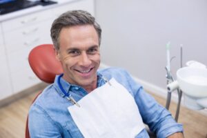 older man smiling the dental chair