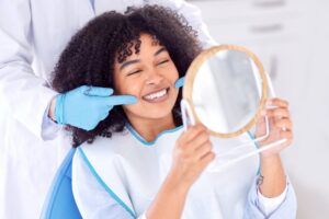 smiling, happy patient after getting her cosmetic dentistry treatment