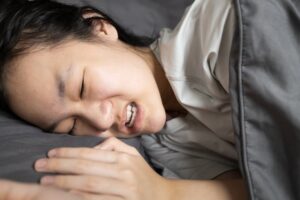 young woman grinding her teeth after a nap